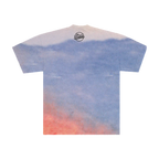Back of a T-shirt with a mountain range background and a black "The Strokes". symbol underneath the neck collar. 